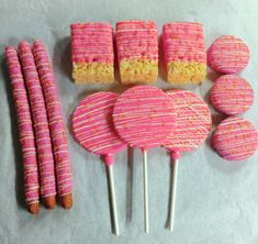 pink and yellow cake pops, marshmallow lollipops, and candy sticks