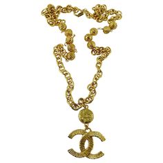 CHANEL vintage gold toned chain necklace featuring a ribbed textured CC logo pendant topped by a CHANEL coin. Spring clasp closure. IMPORTANT INFORMATION : The spring of the clasp is not perfectly functional - it needs to be pushed manually in order to close. That is said, once the clasp is closed it holds perfectly well and you will not need to close and open the necklace as far as it can be slipped around the neck. Embossed Marked CHANEL Made in France. Indicative measurements : chain length a Gold-tone Metal Necklace With Logo Plaque, Gold Chain Necklace With Gold-tone Logo, Gold Chain Necklace With Logo Plaque, Gold Metal Necklaces With Gold-tone Logo Plaque, Vintage Gold Necklace With Gold-tone Logo Plaque, Vintage Jewelry With Gold-tone Logo Plaque, Gold-tone Metal Chain Necklace With Logo Charm, Vintage Gold-tone Chain Necklace With Coin Pendant, Gold Metal Necklace With Logo Charm