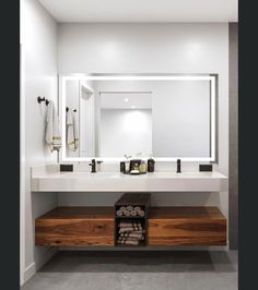 a bathroom with two sinks and mirrors in it