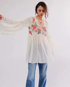 So femme and floral-adorned, this chic tunic is featured in a soft fabrication and billowy silhouette with bold bell-shaped sleeves and subtle ruffled trim. Fit: Billowy, shapeless silhouette; tunic-length styleFeatures: Soft fabrication with a lightweight feel, square neckline, embroidered floral detailing, bell-shaped sleeves, subtle ruffled trim, gathered detail for added dimensionWhy We ❤ It: This billowy top can be layered over your favorite shorts or slouchy pants for effortlessly versatil Spring Dress With Embroidered Bishop Sleeves, Spring Bohemian Blouse With Elastic Sleeves, Bohemian Peasant Top With Elastic Sleeves For Spring, Spring Bishop Sleeve Blouse With Floral Embroidery, Spring Floral Embroidered Blouse With Bishop Sleeves, Spring Floral Embroidery Blouse With Bishop Sleeves, Summer Bishop Sleeve Peasant Top, Flowy Blouse With Elastic Sleeves, Bohemian Blouse With Balloon Sleeves For Brunch