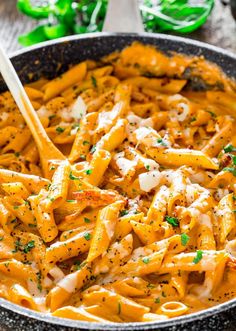 a skillet filled with pasta and cheese