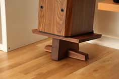 a wooden object sitting on top of a hard wood floor