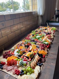 Cheese and meat and fruit appetizer grazing table charcuterie spread Wedding Crackers, Long Cheese Board, Wedding Cheese Board, Engagement Food, Long Charcuterie Board, Wedding Grazing Table, Fruit Crackers, Charcuterie Meats, Cheese Table