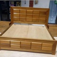 a wooden bed frame with drawers and headboard in the foreground, along with other wood furniture