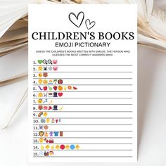 the children's books emoj dictionary is on top of a pile of feathers