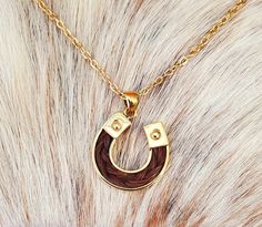 24K Gold overlay 925 Sterling Silver Horse Hair Horseshoe Pendant Necklace.  Pendant is approximately 25mm x 25mm and includes braided horse hair.  This beautiful pendants can be made with your horse's hair or we can make it with our stock horse hair.   Add engraving to your Pendant:  https://blueeyesdesignshb.etsy.com/listing/1769925811 Add a Custom Engraved Wood Gift Box: https://blueeyesdesignshb.etsy.com/listing/1750883342 Some of my other pendants can also be Gold Plated - Just ask! Pendants include a Gold Plated Stainless Steel Necklace Chain that is 18" long See my other horse hair keepsakes:  https://www.etsy.com/shop/BlueEyesDesignsHB?ref=seller-platform-mcnav§ion_id=43697745 -If you want something custom made, email me at BlueEyesDesignsHB@gmail.com -I will send an Etsy message w Horse Hair Necklace, Wood Engraved Gifts, Stock Horse, Hair Keepsake, Horse Hair Jewelry, Beautiful Pendants, Hair Necklace, Wood Gift Box, Boot Bracelet