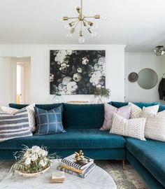 a living room with blue couches and pillows on top of the sofa is featured in an instagram