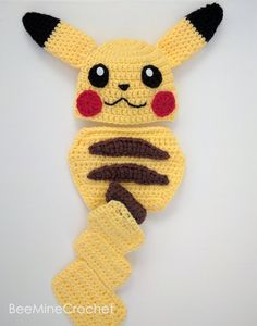 a crocheted pikachu is hanging on the wall