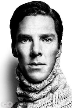 a black and white photo of a man wearing a scarf