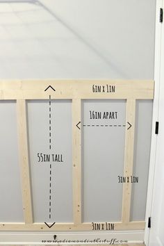 the measurements for an unfinished wall in a room with white walls and wood flooring