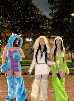 three women dressed in costumes standing next to each other