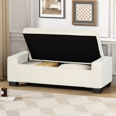 a living room with a white couch and coffee table on top of the carpeted floor