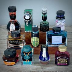 several different types of perfume bottles on a wooden table