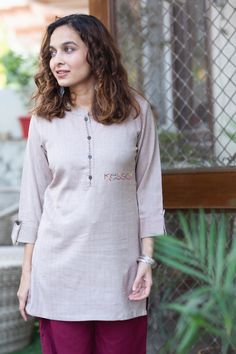 Tailored out of 100% premium Pashmina, Laksha is a promise of toasty coziness and velvety soft skin feel. The sophisticated beige top features wooden buttons that add to its organic allure, while dainty Kantha work adds a touch of intricacy to the piece. The collared round neckline and relaxed 3/4 sleeves boost its graceful beauty.