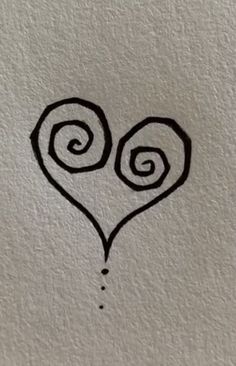 a heart drawn on the wall with two spirals in it's center and an ink drop at the bottom