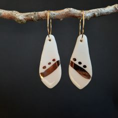 PORCELAIN and GOLD EARRINGS- with 22 Karat Gold Glaze: Handmade, Art Design, One of a kind ABOUT MY PROCESS: This is a one-of-a-kind set, from my gold luster hand-painted series. Each earring is individually crafted, by me; the glazes on this one create a unique, non-reproducible blend.  The white translucent glaze and the gold work well together. The metal elements are gold fill or gold-plated findings and wires I create  with Porcelain is a high or mid-range fired natural clay made of superfine particles. It can become translucent and glass-like. (Firings go over 2000 degrees Fahrenheit) It is not an easy material to work with, but I love the results! White Artisan Hand-painted Earrings, White Hand Painted Artisan Earrings, One Of A Kind Gold Teardrop Earrings, Hand Painted Gold Dangle Jewelry, Gold Hand Painted Dangle Jewelry, Artistic Hand Painted Gold Earrings, Gold Hand-painted Teardrop Earrings, Gold Hand Painted Teardrop Earrings, Gold Teardrop Earrings Hand Painted