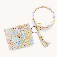 a keychain with a flower print on it and a card holder attached to it