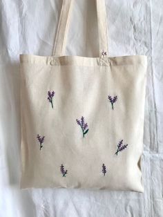 a white bag with purple flowers on it