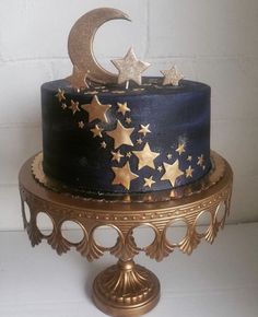 a blue and gold cake with stars on it