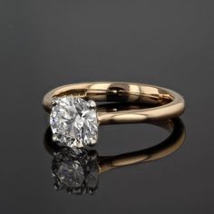 a diamond ring on a black surface