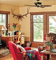 a living room filled with furniture and a fire place in front of a large window