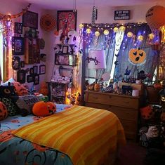 a bedroom decorated for halloween with pumpkins and decorations