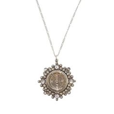 The San Benito Medallion with an elegant beaded bezel embellished with dazzling Swarovski Crystals, on a 32" chain. The San Benito is a symbol of faith and protection, and a classic part of VSA designs collections. Pendant is 1.5" in diameter Gold or Silver vermiel with Swarovski crystals Chain is 32" Long Signature VSA Designs packaging Elegant Silver Necklace For Blessing, Elegant Silver Necklaces For Blessings, Spiritual Medallion Jewelry With Box Chain, Elegant Silver Necklace For Blessing Occasions, Silver Chain Medallion Jewelry, Spiritual Antique Silver Medallion Necklace, Spiritual Antique Silver Coin Pendant Jewelry, Sterling Silver Medallion For Blessing Occasion, Silver Locket Jewelry For Blessing