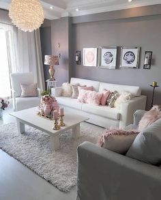 a living room filled with white furniture and pink accents