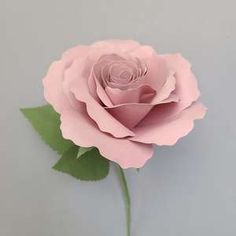 a single pink rose with green leaves on a gray background, ready to be cut into smaller pieces