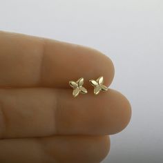 These are flower stud earrings, handmade of yellow 14k solid gold.  Their finish is shiny, and they are comfortable to wear. Small and dainty, these unique gold studs are perfect for everyday's wear.  Great as a gift as they can be enjoyed at any age and outfit. 14k solid gold ear backs are included. Size of the earrings is 5.3 x 5.8 mm = approx. 0.2 x 0.22 inch * The earrings will be packed in a gift box ready to give as a gift, and shipped via Express mail service which usually takes 4-6 business days to arrive. * For more gold earrings please click here:  https://www.etsy.com/shop/SigalGerson?section_id=13604349 To get back to my shop: http://www.etsy.com/shop/sigalgerson 14k Gold Flower Earrings For Gift, Dainty Yellow Gold Pierced Flower Earrings, Yellow Gold Hallmarked Flower Earrings For Gift, 14k Gold Flower Earrings For Pierced Ears, 14k Yellow Gold Flower Earrings, Dainty 14k Gold Pierced Flower Earrings, Dainty Yellow Gold Flower Earrings For Gifts, Dainty Yellow Gold Flower Earrings For Anniversary, 14k Gold Flower Shaped Earrings For Gift