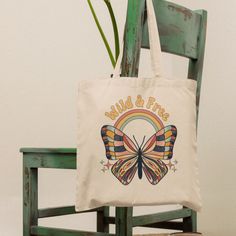 "This retro butterfly canvas tote bag is perfect for your everyday needs! The cute and trendy retro butterfly design with the quote \"wild & free\" is sure to turn heads.  With a height of nearly 16 inches and a width of approximately 15 inches, it's the perfect size for carrying your essentials, whether you're headed to the gym or running errands. Its handle has a comfortable length of 21 and a half inches, and the bag is constructed of 100% cotton sheeting. Additionally, the reinforced handle Everyday Butterfly Print Tote Bag, Retro Cotton Bags For Spring, Retro Canvas Tote Bag For Gift, Retro Summer Canvas Bag, Retro Canvas Bag As A Gift, Retro Summer Cotton Canvas Bag, Retro Summer Canvas Cotton Bag, Retro Cotton Canvas Bag For Summer, Retro Cotton Bag As Gift