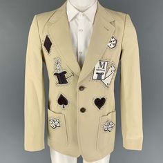 Viktor & Rolf Sport Coat Comes In A Beige Cotton With A Full Liner Featuring A Notch Lapel, Embroidered Designs, Rhinestone Details, Patch Pockets, Single Back Vent, And A Double Button Closure. Made In Italy. New With Tags. Marked: 46 Measurements: Shoulder: 17.5 Inches Chest: 38 Inches Sleeve: 26.5 Inches Length: 29.5 Inches Sui Generis Reference: 119379 Category: Sport Coat More Details Brand: Viktor & Rolf Size: 36 Chest Size: 36 Gender: Male Color: Beige Pattern: Applique Fabric: Cotton / M Embroidered Designs, Beige Pattern, Viktor Rolf, Viktor & Rolf, Applique Fabric, Metal Style, Embroidered Design, Sport Coat, Fabric Cotton