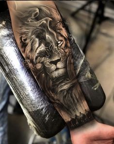 a man's arm with a lion tattoo on it, and his hand holding the arm