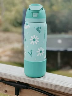 a blue water bottle sitting on top of a wooden bench