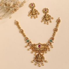 Product Description The Mrinali necklace set is designed in a vintage theme on a shining antique gold base to enhance your poise. The gleaming CZ stones add a highlight to this set making this best to choose for weddings and festivals. Style this set with a saree or layer with other antique necklace sets. Details & Specifications: Materials used: Antique Gold Plated Brass Weight -Necklace: 38 gms, Earrings: 17 gms, Length - Necklace: 13.5 cms, Earrings: 4.5 cms, Make it custom Want to make it a Gold Necklace Set With Jumka, Gold Dual-tone Bridal Necklace For Festive Occasions, Festive Dual-tone Gold Bridal Necklace, Antique Gold Necklace For Diwali Festive Season, Antique Gold Necklaces For Festive Celebrations, Antique Gold Necklace For Festive Celebrations, Festive Gold Dual-tone Temple Necklace, Festive Dual-tone Gold Temple Necklace, Festive Dual-tone Temple Jewelry Sets