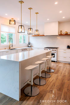 a kitchen with an island and four stools