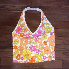 White Cropped Halter Top With Orange, Pink, And Yellow Flowers New Without Tags Size Xs, Fits Like An Xs/Small Length: 15 In Cute V-neck Tank Top For Spring, Cute V-neck Crop Top For Spring, Spring Y2k Halter Neck Top, Y2k Halter Neck Top For Spring, Y2k Style Halter Neck Tops For Spring, Multicolor Y2k Tank Top For Spring, Y2k Multicolor Tank Top For Spring, Y2k Style Multicolor Tank Top For Spring, Y2k Printed Tank Top For Spring