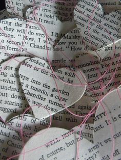 several pieces of paper with pink thread on top of each other in the shape of hearts