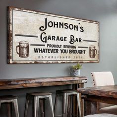 an old fashioned sign is hanging on the wall above a bar and dining room table