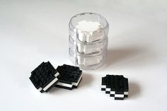 three pieces of black and white legos sitting next to each other