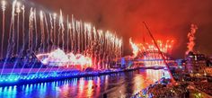 fireworks are lit up in the sky above a river