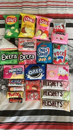 a pile of candy sitting on top of a bed