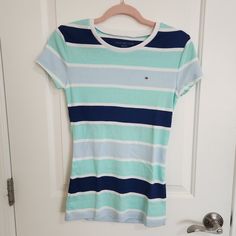 Tommy Hilfiger Striped Crew Neck Tee, Brand New Without Tag. Brightly Colored In Stripes Of White, Navy Blue, Sky Blue And Aqua Green, Perfect For The Summer. Short Sleeves, Stretchy Cotton Jersey. Size S Length 25" Chest 31" 100% Cotton Non-Smoking Home Tommy Hilfiger Striped Tops For Spring, Tommy Hilfiger Short Sleeve Tops For Spring, Tommy Hilfiger Blue Tops For Spring, Tommy Hilfiger Spring Tops With Short Sleeves, Tommy Hilfiger Crew Neck Top For Summer, Fitted Tommy Hilfiger T-shirt For Spring, Tommy Hilfiger Summer Crew Neck Top, Tommy Hilfiger Fitted T-shirt For Spring, Tommy Hilfiger Striped Tops For Summer