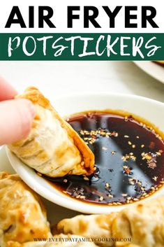 a hand dipping sauce onto some food in a white bowl with the words air fryer potstickers on it