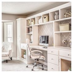 a home office area with white furniture and shelving units on either side of the room