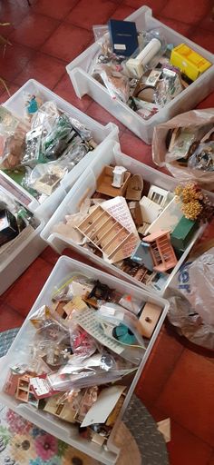 several boxes filled with assorted items on top of a red tiled floor next to each other