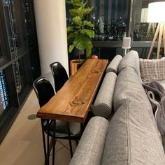 a living room filled with furniture and a wooden table