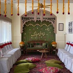 a living room filled with lots of furniture and decor on top of a carpeted floor