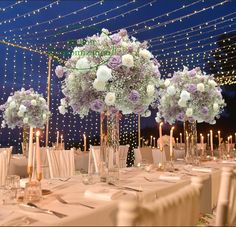 the tables are set with white and purple flowers