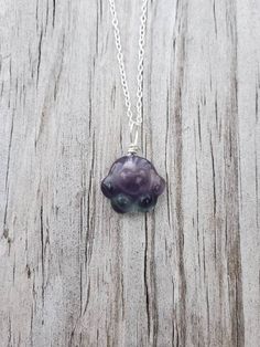 "This paw necklace features a piece of natural Rainbow Fluorite carved in paw print shape.  You will get a random piece from the ones shown in the pictures unless you contact me and choose your own paw. The actual paws are much brighter and prettier in person! The paws are drilled, and wire wrapped by Eva with 22-gauge solid sterling silver. You can choose just a paw, or you can choose to have sterling silver chain (as featured picture) or stainless-steel chain, with your choice of chain length. Paw Print Pendant Necklace For Gifts, Paw Print Pendant Necklace For Gift, Paw Print Pendant Necklace Gift, Pendant Necklace With Paw Print For Gift, Sterling Silver Paw Print Necklace For Gift, Round Pendant Necklace With Paw Print For Gift, Paw Pendant, Paw Print Pendant, Paw Necklace